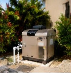Pool heat pump installed beside a South Florida home — Pool Heaters in Wellington