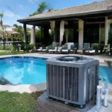 Heat pump pool heater hidden in a fenced side yard between a stucco wall and wooden fence