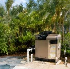 Heat pump pool heater hidden in a fenced side yard between a stucco wall and wooden fence