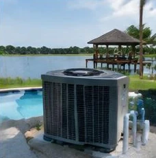 Pool heat pump installed beside a South Florida home — Pool Heater Repair in Delray Beach