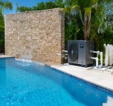 Heat pump pool heater hidden in a fenced side yard between a stucco wall and wooden fence