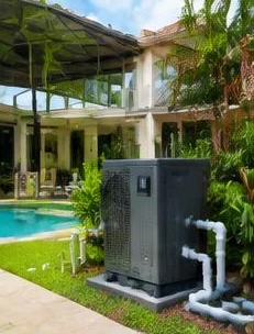 Heat pump pool heater hidden in a fenced side yard between a stucco wall and wooden fence