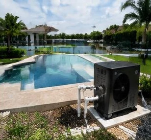 Heat pump pool heater hidden in a fenced side yard between a stucco wall and wooden fence