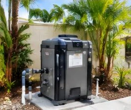Heat pump pool heater hidden in a fenced side yard between a stucco wall and wooden fence