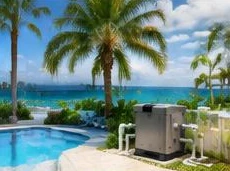 Pool heat pump installed beside a South Florida home — Pool heaters in West Palm Beach