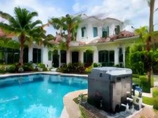 Pool heat pump installed beside a South Florida home — Residential Pool Heaters in Boynton Beach