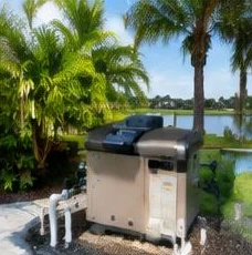 Heat pump pool heater hidden in a fenced side yard between a stucco wall and wooden fence