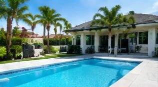 Heat pump pool heater hidden in a fenced side yard between a stucco wall and wooden fence