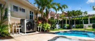 Heat pump pool heater hidden in a fenced side yard between a stucco wall and wooden fence