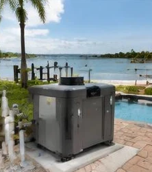 Pool heat pump installed beside a South Florida home — Pool Heater Maintenance in Jupiter Inlet Colony