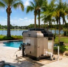 Pool heat pump installed beside a South Florida home — Pool Heaters in Lake Worth Beach