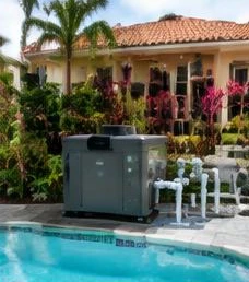 Heat pump pool heater hidden in a fenced side yard between a stucco wall and wooden fence