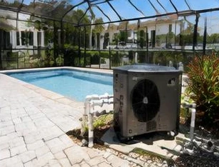 Pool heat pump installed beside a South Florida home — Pool Heater Replacement in Palm Beach County