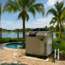 Pool heat pump installed beside a South Florida home — Pool Heaters in Delray Beach