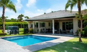 Pool heat pump installed beside a South Florida home — Pool Heaters in Manalapan