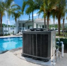Heat pump pool heater hidden in a fenced side yard between a stucco wall and wooden fence