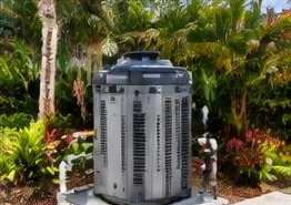 Pool heat pump installed beside a South Florida home — Pool Heater Installation in Palm Beach Gardens