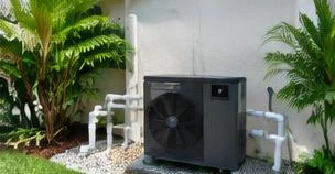 Pool heat pump installed beside a South Florida home — Commercial Pool Heaters in Manalapan