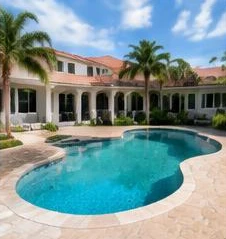 Pool heat pump installed beside a South Florida home — Residential Pool Heaters in Palm Beach County