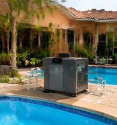 Heat pump pool heater hidden in a fenced side yard between a stucco wall and wooden fence