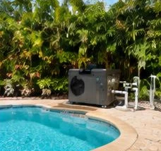 Pool heat pump installed beside a South Florida home — Pool heating for hoa & condominium pools