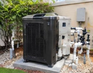 Pool heat pump installed beside a South Florida home — Commercial Pool Heaters in Highland Beach