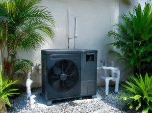 Heat pump pool heater hidden in a fenced side yard between a stucco wall and wooden fence