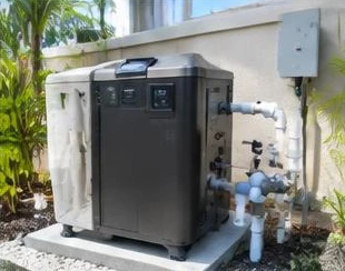 Pool heat pump installed beside a South Florida home — Residential Pool Heaters in Highland Beach