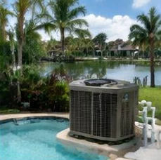 Heat pump pool heater hidden in a fenced side yard between a stucco wall and wooden fence