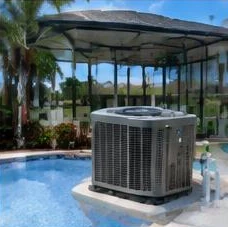 Heat pump pool heater hidden in a fenced side yard between a stucco wall and wooden fence