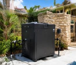 Heat pump pool heater hidden in a fenced side yard between a stucco wall and wooden fence