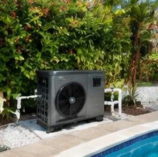 Heat pump pool heater hidden in a fenced side yard between a stucco wall and wooden fence
