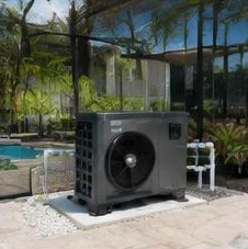 Heat pump pool heater hidden in a fenced side yard between a stucco wall and wooden fence