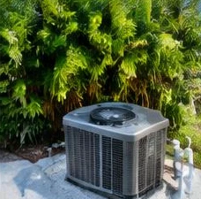 Heat pump pool heater hidden in a fenced side yard between a stucco wall and wooden fence