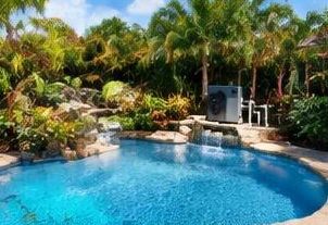 Pool heat pump installed beside a South Florida home — Pool heaters in Manalapan