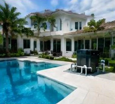 Pool heat pump installed beside a South Florida home — Pool Heaters in Boynton Beach