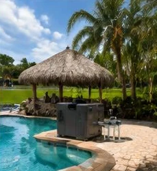 Pool heat pump installed beside a South Florida home — Pool Heater Installation in Jupiter Inlet Colony
