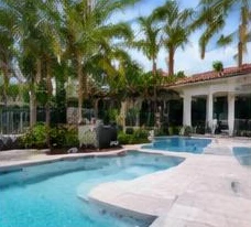 Pool heat pump installed beside a South Florida home — Pool Heater Installation in Boynton Beach