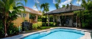 Pool heat pump installed beside a South Florida home — Pool Heater Installation in Gulf Stream