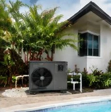 Heat pump pool heater hidden in a fenced side yard between a stucco wall and wooden fence