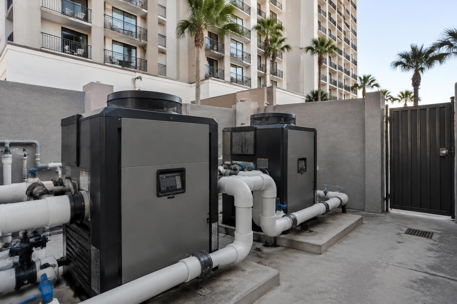 Commercial pool heaters and equipment at a West Palm Beach hotel pool with loungers and palms